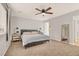 Spacious bedroom with neutral walls, contemporary lamps, a ceiling fan, and comfortable bed at 992 Wagner Valley St, Henderson, NV 89052
