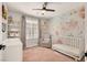 Charming Bedroom with floral wallpaper, crib, chair, and natural light at 992 Wagner Valley St, Henderson, NV 89052