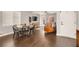 Open-concept dining area with hardwood floors, a modern table set, and a view to the living room at 992 Wagner Valley St, Henderson, NV 89052