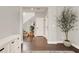 Inviting foyer with hardwood floors, staircase, and stylish storage solutions at 992 Wagner Valley St, Henderson, NV 89052