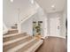 Bright foyer with hardwood floors, staircase, and white trim at 992 Wagner Valley St, Henderson, NV 89052