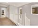 Upstairs hallway with neutral walls, white railing, and carpet flooring with views to other rooms at 992 Wagner Valley St, Henderson, NV 89052