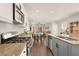 Well-lit kitchen with stainless steel appliances, granite countertops, and an open view to the dining area at 992 Wagner Valley St, Henderson, NV 89052