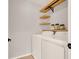 Functional laundry room featuring a washer, dryer, and open shelving at 992 Wagner Valley St, Henderson, NV 89052