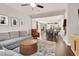 Open-concept living room with a comfortable sectional sofa, hardwood floors, and seamless flow to the dining area at 992 Wagner Valley St, Henderson, NV 89052