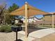 Shaded picnic area with a grill, table, and nearby houses at 992 Wagner Valley St, Henderson, NV 89052