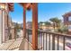 The balcony view showcases lush palm trees, mature landscaping, and sunny skies at 1 Corte Belleza, Henderson, NV 89011