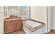 Bathroom featuring a soaking tub with granite trim and a vanity with & mirrors at 1 Corte Belleza, Henderson, NV 89011
