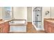 Bathroom features a soaking tub with granite trim and a walk-in shower with glass doors at 1 Corte Belleza, Henderson, NV 89011