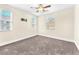 Bedroom featuring neutral carpet, ceiling fan, and three windows at 1 Corte Belleza, Henderson, NV 89011