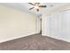Bedroom with carpet, ceiling fan, and closet with sliding doors at 1 Corte Belleza, Henderson, NV 89011