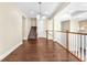 Hardwood floor hallway and staircase features an open railing, offering a bright, airy space at 1 Corte Belleza, Henderson, NV 89011