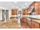 Modern kitchen with island, granite countertops, and stainless appliances at 1 Corte Belleza, Henderson, NV 89011
