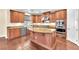 Gourmet kitchen with granite countertops, stainless steel appliances, and a large island at 1 Corte Belleza, Henderson, NV 89011