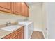 Laundry room with sink, cabinets, and washer and dryer at 1 Corte Belleza, Henderson, NV 89011