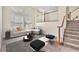 Bright and airy living room with staircase and large windows at 1 Corte Belleza, Henderson, NV 89011