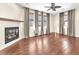 Living room features a fireplace, ceiling fan and hardwood floors at 1 Corte Belleza, Henderson, NV 89011