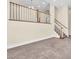 Bright living room with staircase, carpet, and stylish railing at 1 Corte Belleza, Henderson, NV 89011
