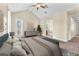 Stylized main bedroom with carpeted floors, ceiling fan, and access to bathroom and walk in closet at 1 Corte Belleza, Henderson, NV 89011