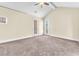 Spacious main bedroom featuring carpeted floors, ceiling fan, and access to outdoor balcony with sliding glass door at 1 Corte Belleza, Henderson, NV 89011