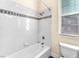 Bathroom shower with white tiled walls and chrome shower head at 1 Corte Belleza, Henderson, NV 89011