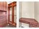 Walk-in closet featuring wooden shelves and custom drawer systems, and a writing desk at 1 Corte Belleza, Henderson, NV 89011