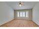 Bright bedroom features neutral carpet, ceiling fan, and a large window seat with shutter blinds at 10009 Netherton Dr, Las Vegas, NV 89134