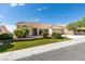 Charming home with a red tile roof, well-manicured lawn, and beautiful landscaping at 10009 Netherton Dr, Las Vegas, NV 89134