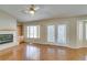 Cozy living room with hardwood floors, a fireplace, built-in shelving, and natural light through glass doors at 10009 Netherton Dr, Las Vegas, NV 89134