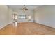 Spacious living room with a mix of hardwood floors and carpet, showcasing high ceilings and natural light at 10009 Netherton Dr, Las Vegas, NV 89134
