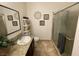 Well-lit bathroom showcasing a vanity with granite counters, a toilet, and a glass-enclosed shower at 1018 Snow Bunting Ct, Henderson, NV 89002