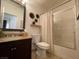 Neutral bathroom featuring a granite countertop, toilet, and shower-tub combo at 1018 Snow Bunting Ct, Henderson, NV 89002