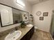 Contemporary bathroom featuring dual sinks, granite countertop, and decorative wall art at 1018 Snow Bunting Ct, Henderson, NV 89002