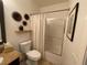 Bright bathroom with a granite countertop, decor, and shower-tub combo at 1018 Snow Bunting Ct, Henderson, NV 89002