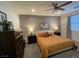Cozy bedroom featuring a plush bed, ceiling fan, and neutral color scheme at 1018 Snow Bunting Ct, Henderson, NV 89002
