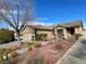 Charming single-story home with a well-manicured front yard, desert landscaping and covered entry at 1018 Snow Bunting Ct, Henderson, NV 89002