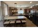 Modern kitchen featuring dark wood cabinets, light countertops, stainless steel appliances, and island with seating at 1018 Snow Bunting Ct, Henderson, NV 89002