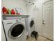 Functional laundry room with a washer, dryer, and storage shelves at 1018 Snow Bunting Ct, Henderson, NV 89002