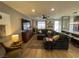 Open-concept living room with sectional sofa, wood floors, and sliding glass doors to the outside at 1018 Snow Bunting Ct, Henderson, NV 89002