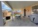Outdoor covered patio with dining set, barbecue, and a fenced yard at 1018 Snow Bunting Ct, Henderson, NV 89002