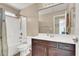 Bright bathroom featuring a shower-tub combo and dark cabinets at 10230 Danskin Dr, Las Vegas, NV 89166