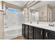 Bathroom featuring a bathtub and a double sink vanity with plenty of cabinet space at 10230 Danskin Dr, Las Vegas, NV 89166