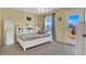 Bright bedroom with a bed, a built-in shelf, and a door to the balcony at 10230 Danskin Dr, Las Vegas, NV 89166