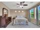 Serene bedroom with a large window, dresser, and comfortable bedding for a peaceful night's rest at 10230 Danskin Dr, Las Vegas, NV 89166