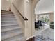 Welcoming staircase with a view of the open floor plan and kitchen at 10230 Danskin Dr, Las Vegas, NV 89166