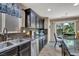 Bright kitchen featuring stainless steel appliances, granite countertops, and sliding glass doors to the backyard at 10230 Danskin Dr, Las Vegas, NV 89166