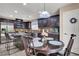 Inviting kitchen boasts dark cabinets, granite countertops, stainless steel appliances and a cozy breakfast nook at 10230 Danskin Dr, Las Vegas, NV 89166