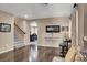 Open-concept living room with hardwood floors, staircase, and view into the kitchen at 10230 Danskin Dr, Las Vegas, NV 89166