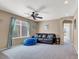 Cozy living room with a leather couch, a window, and a ceiling fan at 10230 Danskin Dr, Las Vegas, NV 89166