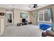 Relaxing living room with TV, a comfortable blue beanbag, and a view into an office space at 10230 Danskin Dr, Las Vegas, NV 89166